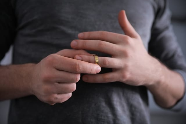 man removing wedding ring