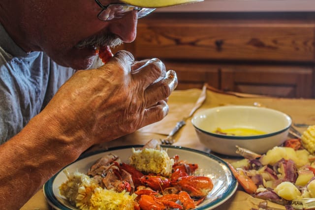 man eating crawfish southern food