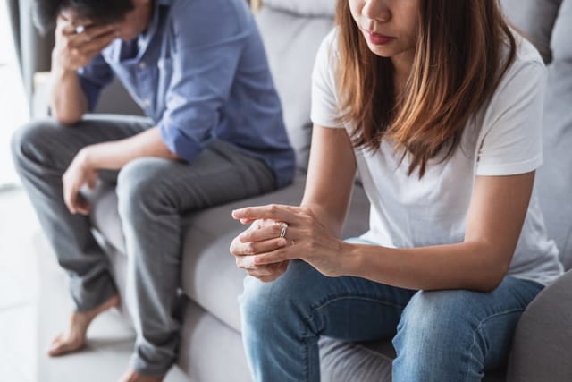 Woman removes her wedding band.