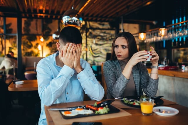 Couple arguing in a restaurant.