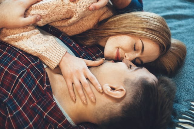 Man and woman embracing.