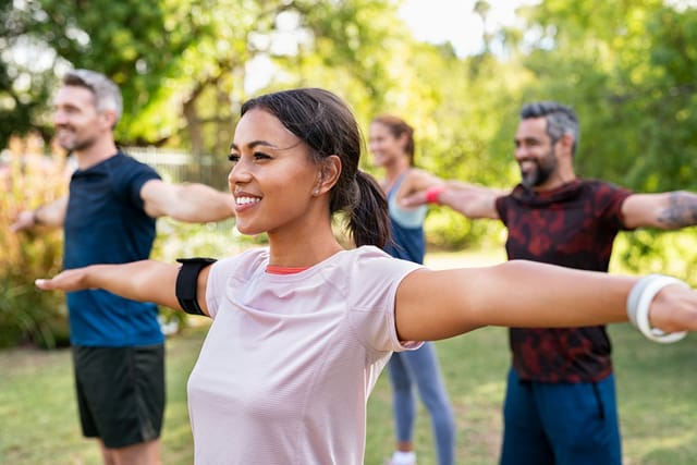 Group of people stretching together before a workout.