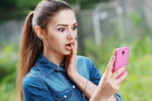Woman reading the headlines on her phone.