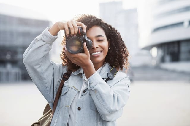 Woman taking photo on camera.