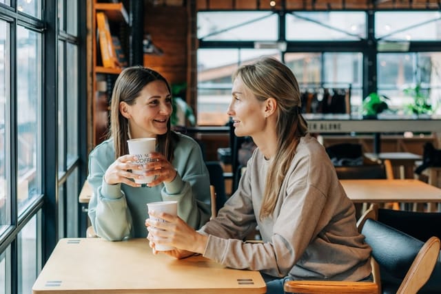 two friends gossiping at coffe shop