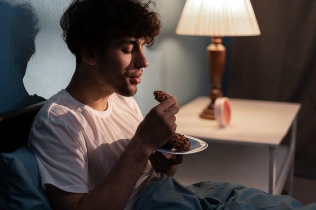 Man eating a baked good.
