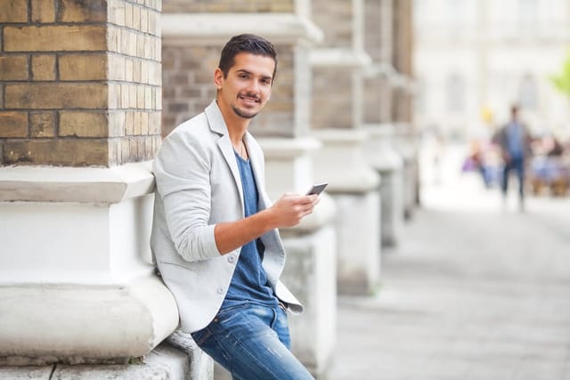 Businessman outside on his phone.