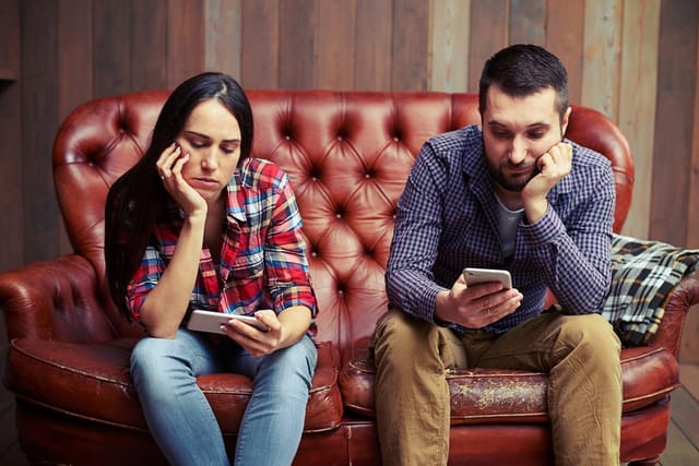Couple bored with one another.
