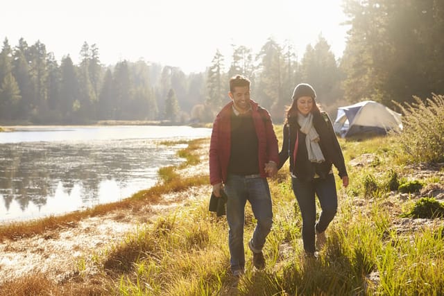 Couple camping near a lake.