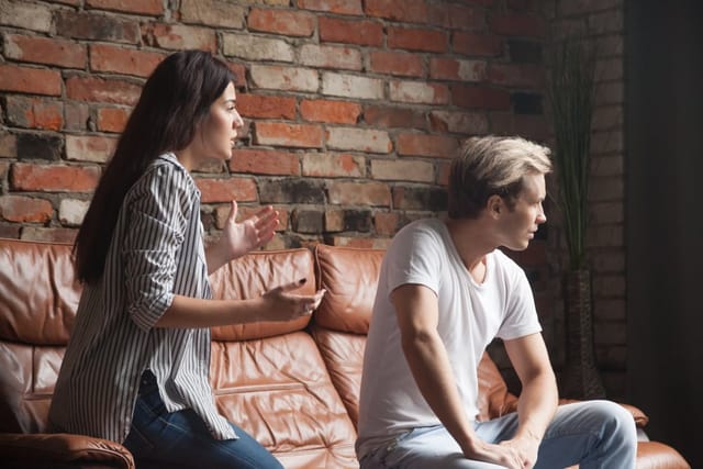 Unhappy couple arguing.