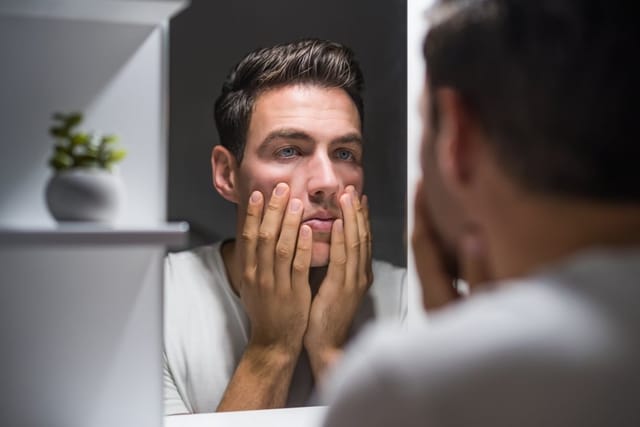 Man looking in the mirror.