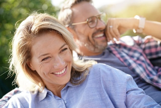 Couple smiling together outdoors.