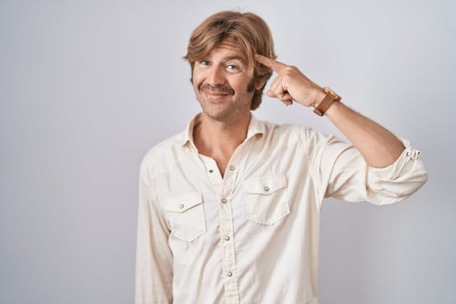 Man pointing to his brain.