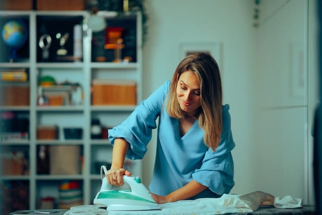 Woman ironing at home.