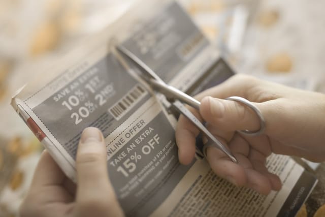 Woman clipping coupons.