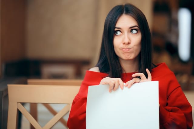 Woman tearing up a document.