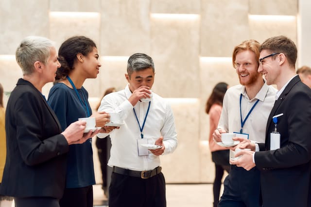 businesspeople talking at conference