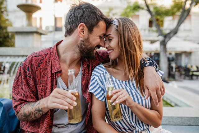 couple having beer outside cafe