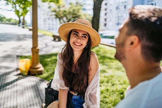 laughing couple enjoying sunny day in park
