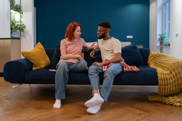 couple having serious talk on couch
