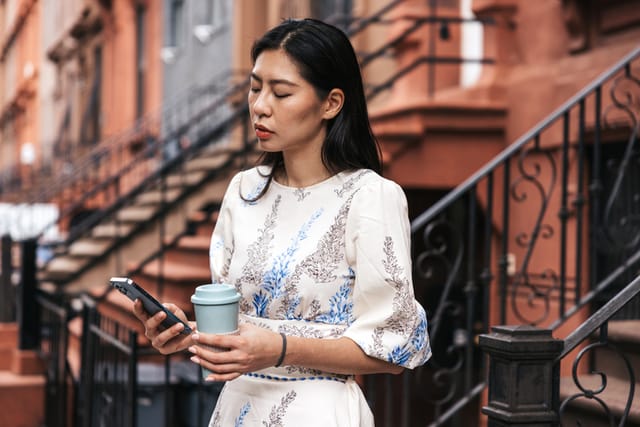 serious woman texting in nyc