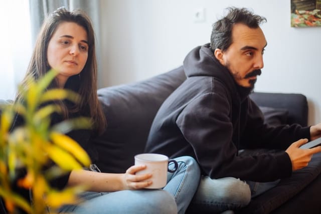 bored couple sitting on couch together