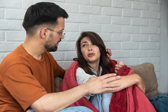 couple sitting on the couch talking