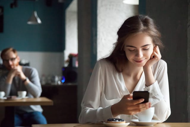 man staring at woman at cafe