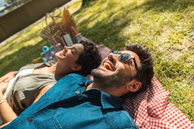 couple lying on picnic blanket