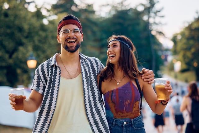 laughing couple walking at festival