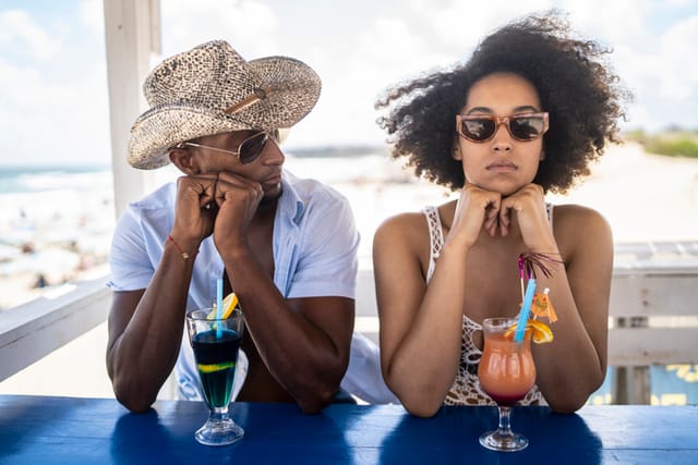 angry woman at beach with boyfriend