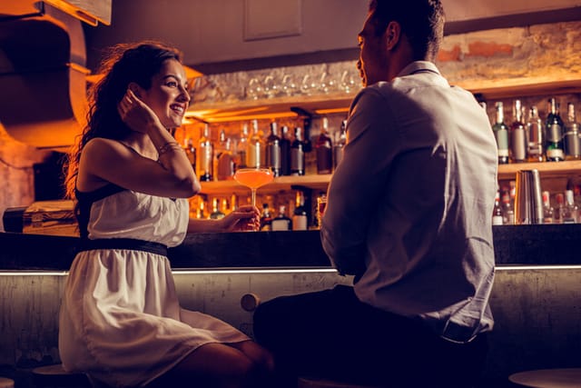 couple flirting at bar