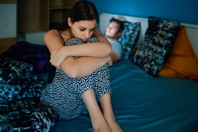 upset woman awake in bed