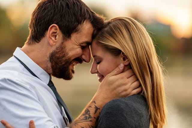 couple embracing touching foreheads