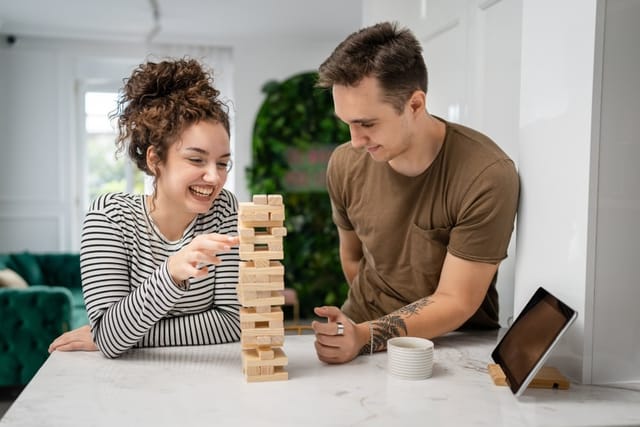 Man and woman playing Jenga.