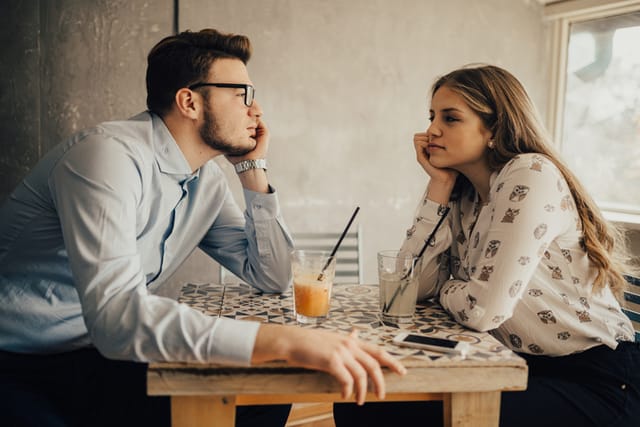 couple staring at each other in restaurant