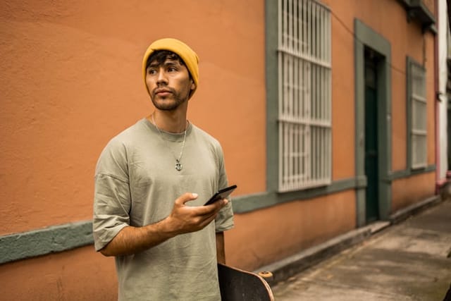 guy texting out on city street