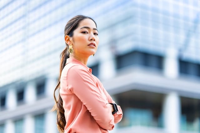 woman with arms crossed outdoors