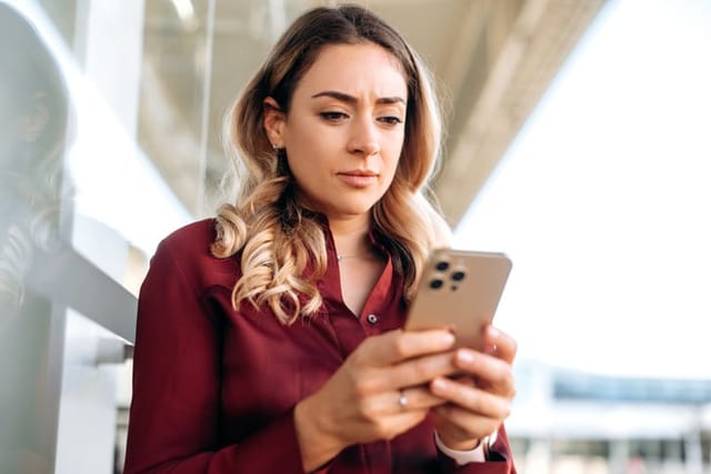 frustrated blonde woman texting