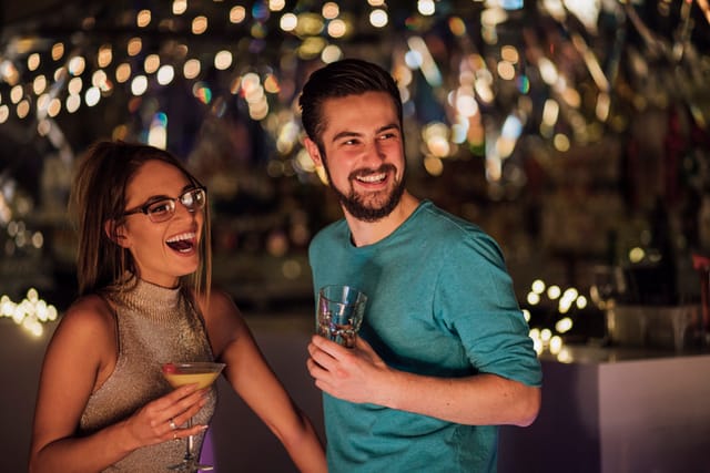 couple having drinks and laughing