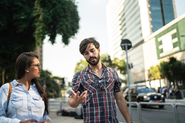man and woman walking down street
