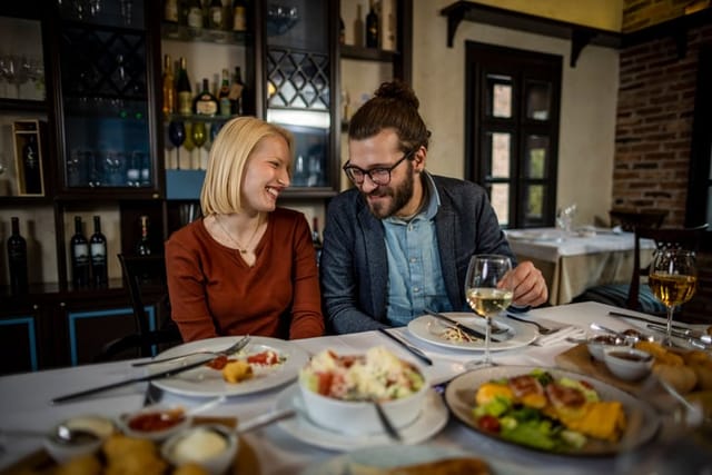 Photo of young couple having date at restaurant