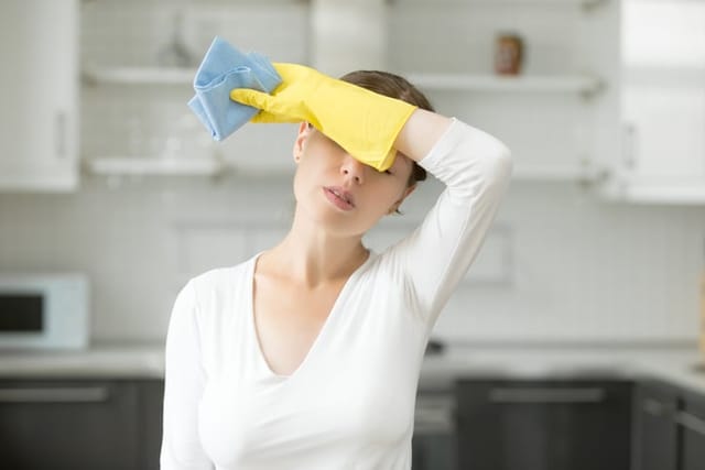 Woman tired from cleaning.