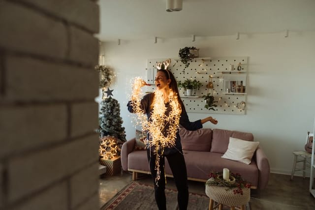 woman dancing in christmas garland