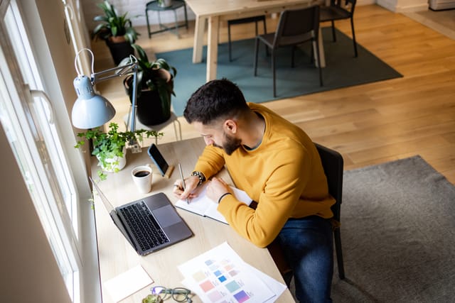 man working at desk from above