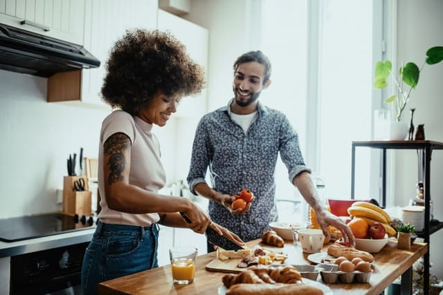 Heterosexual couple cooking lunch or preparing dinner together