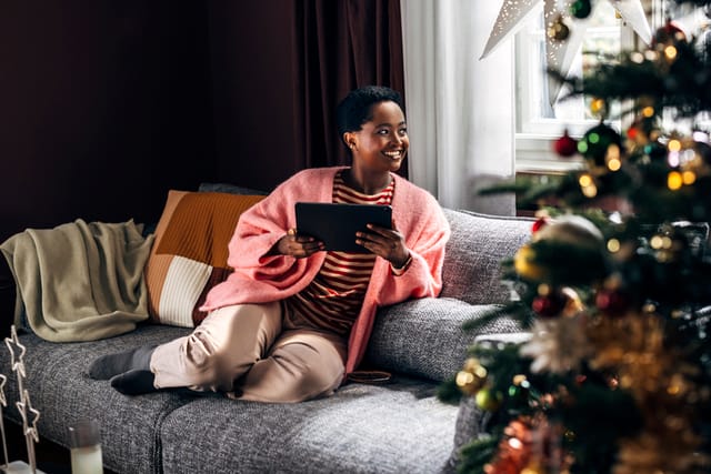 woman on tablet on couch