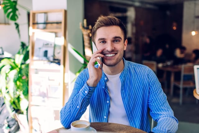 smiling guy talking on phone