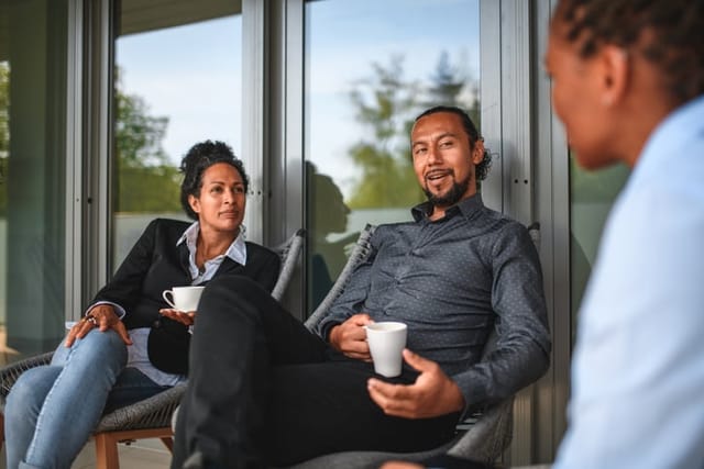 colleagues having a discussion with coffee