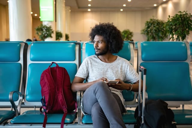 guy sitting at gate in airport